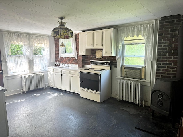 221 Diamond St, Pen Argyl, PA 18072 - kitchen with healthy amount of natural light, white electric range, and radiator heating unit