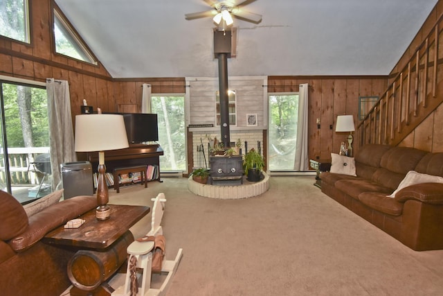118 Sussex Ct, Bushkill, PA 18324 - living area with a wood stove, wooden walls, plenty of natural light, ceiling fan, and lofted ceiling
