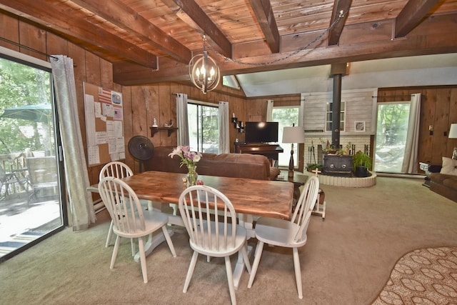 118 Sussex Ct, Bushkill, PA 18324 - dining room with a wood stove, wood walls, carpet flooring, and wooden ceiling