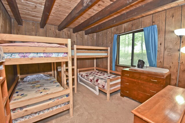118 Sussex Ct, Bushkill, PA 18324 - carpeted bedroom featuring wooden walls and a wooden ceiling with exposed beams