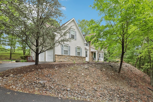 136 Outlook Ct, East Stroudsburg, PA 18302 - view of front of house featuring asphalt driveway and stone siding