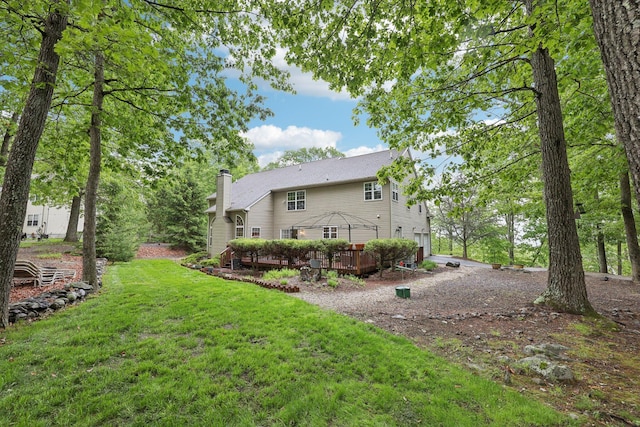 136 Outlook Ct, East Stroudsburg, PA 18302 - rear view of house featuring a chimney, a deck, a yard, and driveway