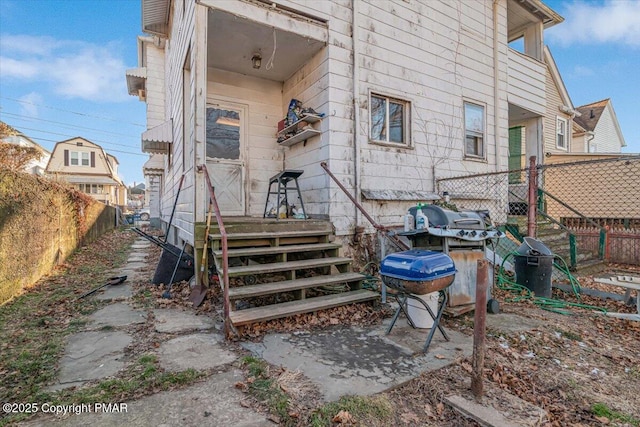 rear view of house featuring fence