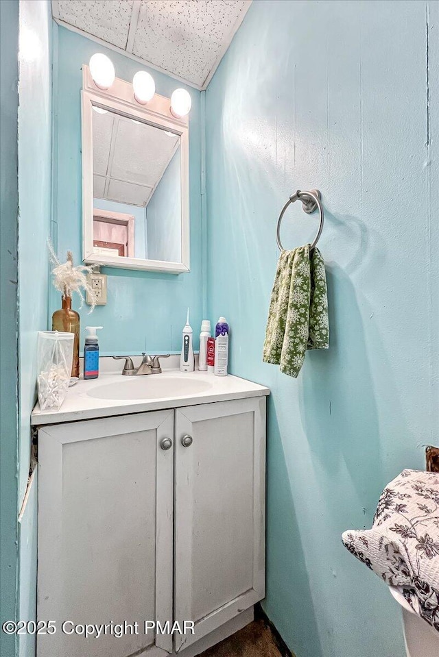 bathroom with a drop ceiling and vanity