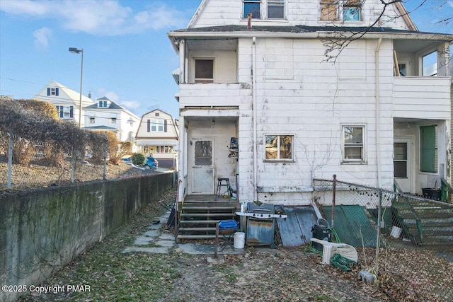 rear view of property with fence