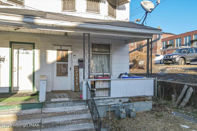 view of exterior entry with covered porch