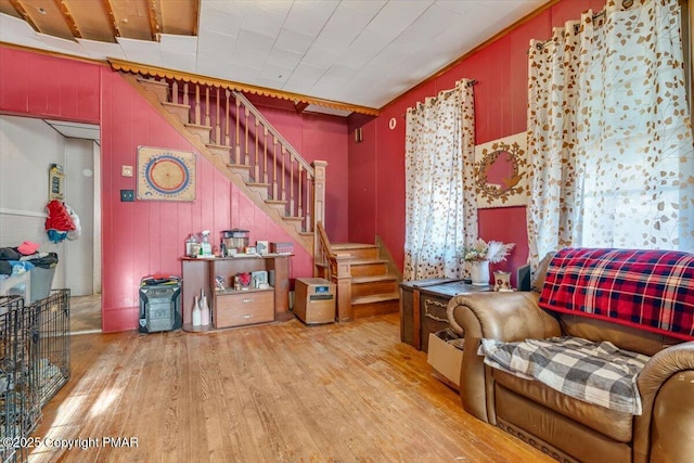 sitting room featuring stairs and light wood-style floors