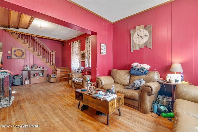 living area with stairway and hardwood / wood-style floors