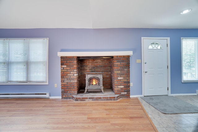 3055 Briarwood Dr, Tobyhanna, PA 18466 - unfurnished living room featuring a baseboard heating unit, recessed lighting, and wood finished floors