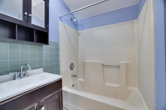 3055 Briarwood Dr, Tobyhanna, PA 18466 - bathroom featuring bathtub / shower combination, vanity, tasteful backsplash, and tile walls
