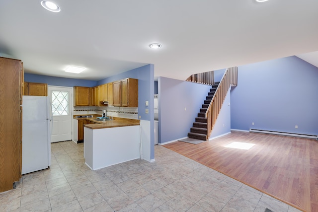 3055 Briarwood Dr, Tobyhanna, PA 18466 - kitchen with freestanding refrigerator, a baseboard radiator, open floor plan, brown cabinets, and recessed lighting
