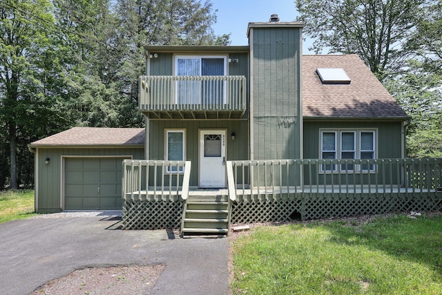 3055 Briarwood Dr, Tobyhanna, PA 18466 - view of front of home with roof with shingles, a chimney, driveway, a garage, and a balcony