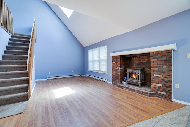 3055 Briarwood Dr, Tobyhanna, PA 18466 - unfurnished living room with a baseboard radiator, a skylight, stairs, lofted ceiling, and wood finished floors