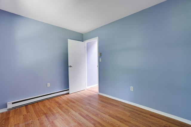 3055 Briarwood Dr, Tobyhanna, PA 18466 - empty room with baseboard heating and wood finished floors