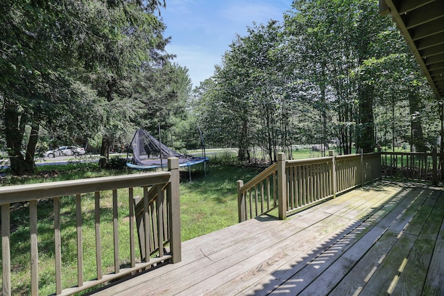 3055 Briarwood Dr, Tobyhanna, PA 18466 - wooden terrace featuring a trampoline, a yard, and view of scattered trees