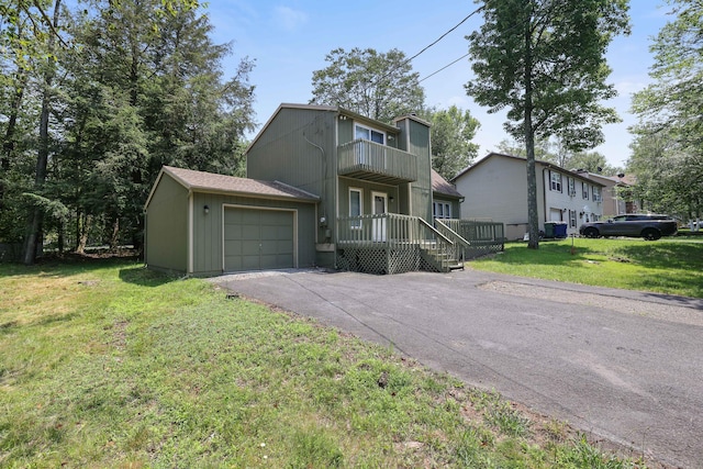 3055 Briarwood Dr, Tobyhanna, PA 18466 - view of front of house featuring a balcony, a front yard, asphalt driveway, and an attached garage