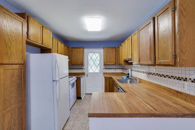 3055 Briarwood Dr, Tobyhanna, PA 18466 - kitchen with white appliances, tasteful backsplash, a peninsula, and light tile patterned floors