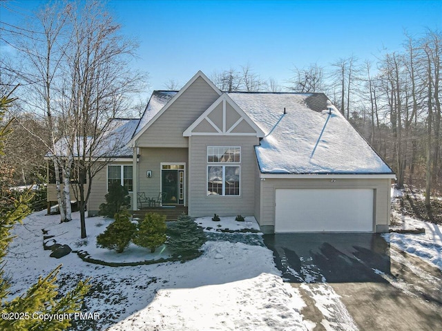 view of front facade featuring an attached garage and aphalt driveway