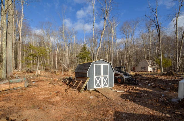 view of shed featuring a view of trees