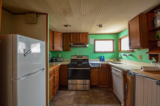 kitchen featuring under cabinet range hood, white appliances, a sink, light countertops, and open shelves