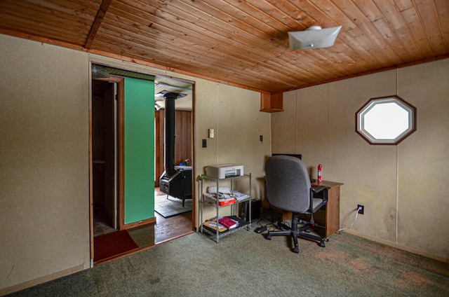 carpeted office space with a wood stove and wooden ceiling