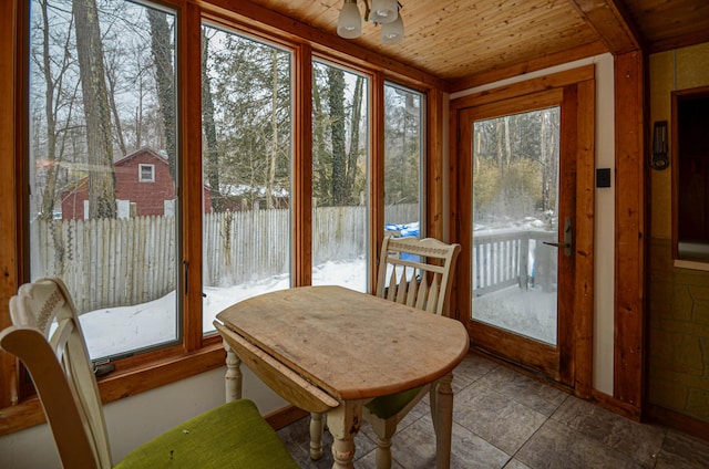 sunroom / solarium with wood ceiling and a healthy amount of sunlight