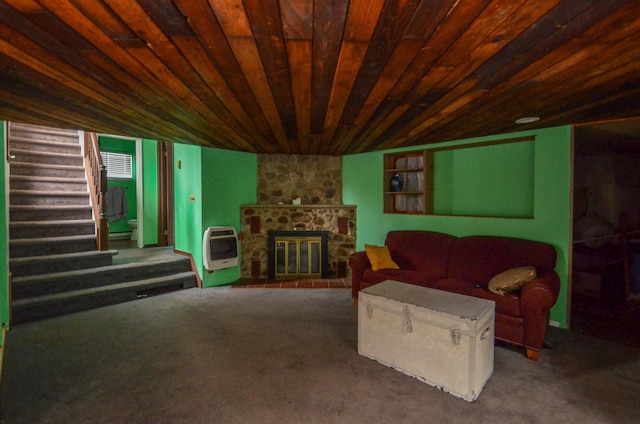 carpeted living room featuring wood ceiling, a stone fireplace, heating unit, and stairs