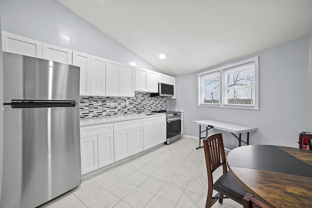 202 Palomino Pl, Tobyhanna, PA 18466 - kitchen with stainless steel appliances, lofted ceiling, backsplash, light tile patterned floors, and a sink