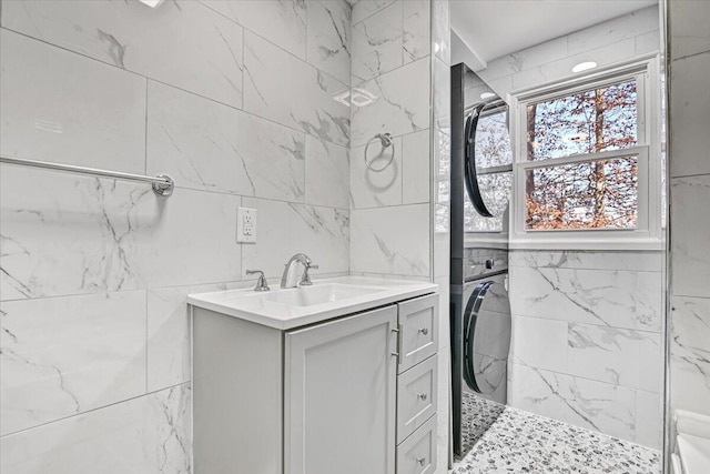 202 Palomino Pl, Tobyhanna, PA 18466 - bathroom with estacked washer and dryer, a tile shower, vanity, and tile walls