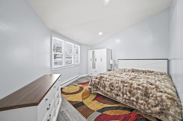 202 Palomino Pl, Tobyhanna, PA 18466 - bedroom with baseboard heating, wood finished floors, vaulted ceiling, and baseboards