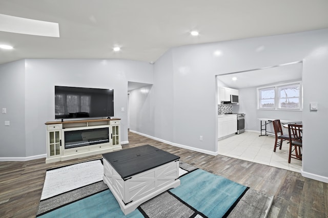 202 Palomino Pl, Tobyhanna, PA 18466 - living area featuring wood finished floors, recessed lighting, lofted ceiling, and baseboards