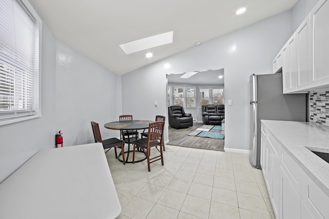 202 Palomino Pl, Tobyhanna, PA 18466 - dining area with a skylight, vaulted ceiling, light tile patterned flooring, recessed lighting, and baseboards