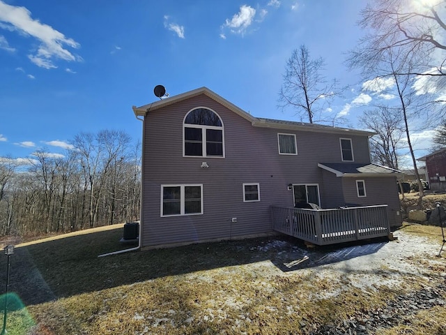 rear view of property with central AC unit and a wooden deck