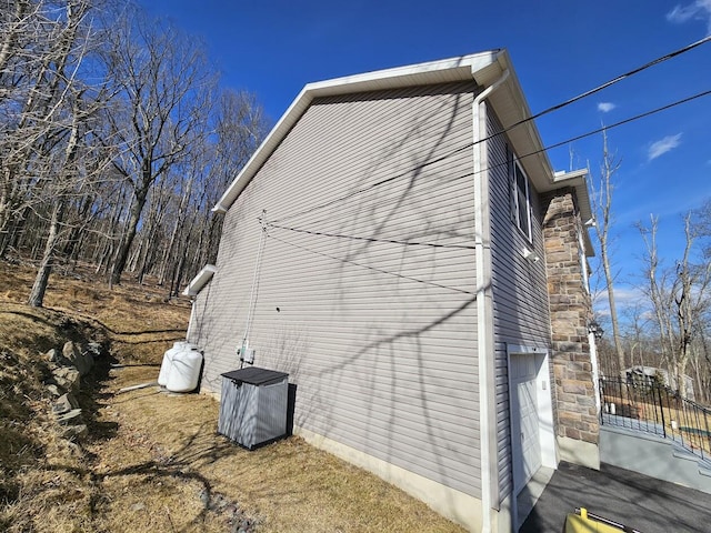 view of side of home featuring a garage and driveway