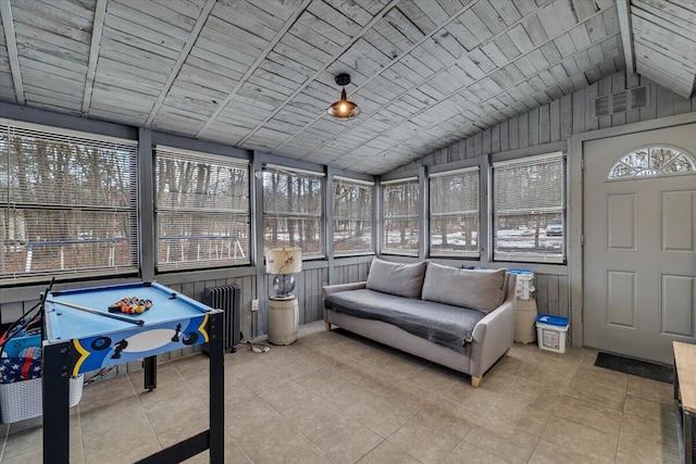 sunroom / solarium with lofted ceiling, wooden ceiling, visible vents, and radiator heating unit