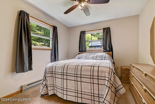 carpeted bedroom with baseboards, baseboard heating, and ceiling fan