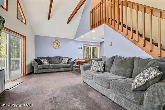 living room featuring beamed ceiling, carpet flooring, a wealth of natural light, and high vaulted ceiling