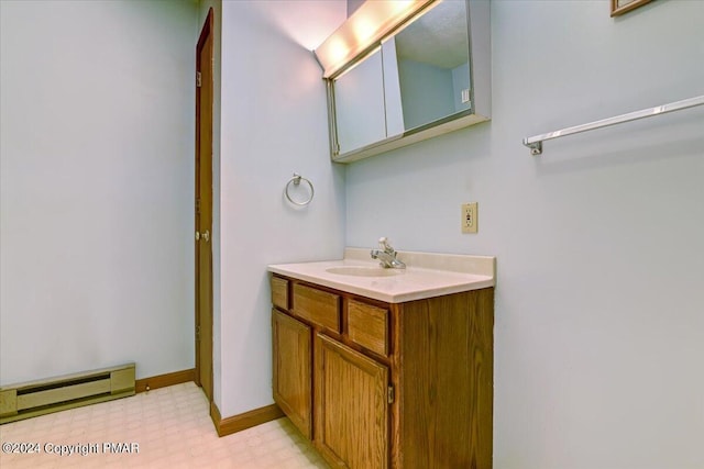 bathroom with tile patterned floors, baseboards, baseboard heating, and vanity