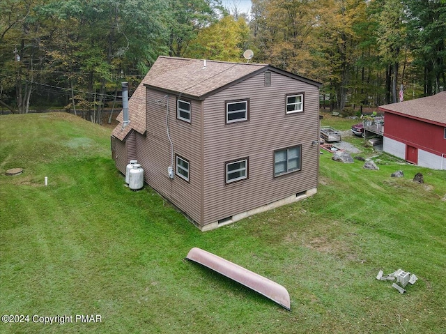 view of home's exterior with crawl space, a lawn, and a chimney