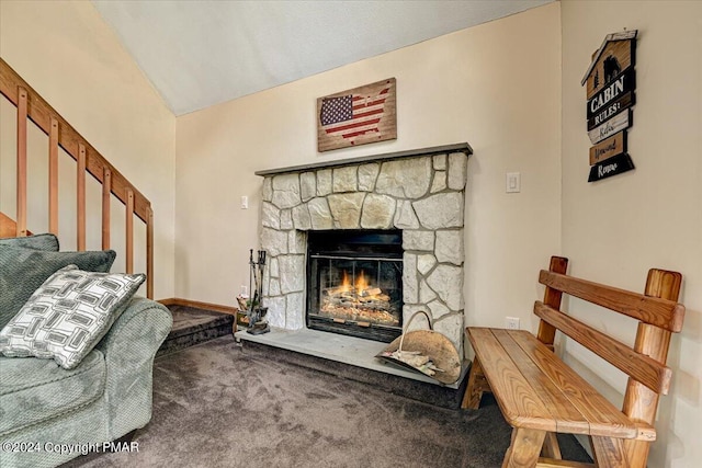 living room with baseboards, carpet floors, lofted ceiling, and a stone fireplace