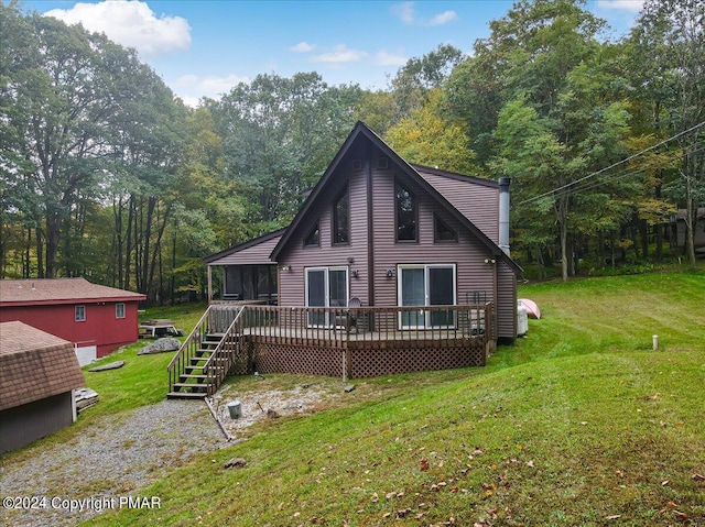 back of house with a yard, a forest view, and a wooden deck