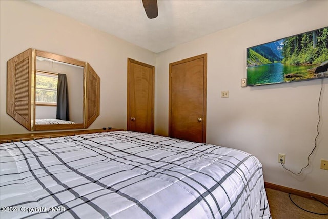 carpeted bedroom featuring baseboards and a ceiling fan