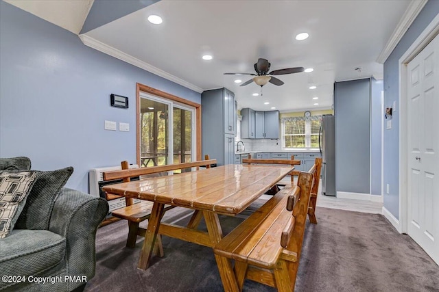 carpeted dining area with crown molding, recessed lighting, baseboards, and ceiling fan