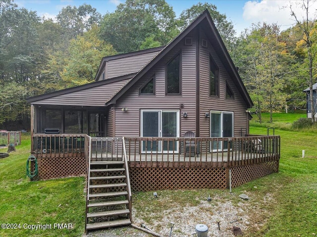 rear view of property featuring a yard, stairway, a wooden deck, and a sunroom