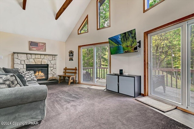 carpeted living area featuring a stone fireplace, beam ceiling, and high vaulted ceiling