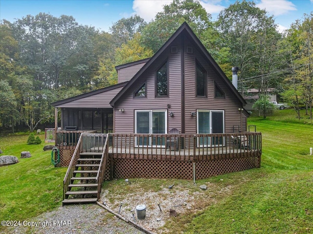 back of house featuring stairway, a yard, a sunroom, and a wooden deck