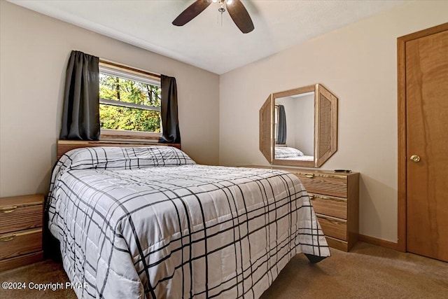 carpeted bedroom with baseboards and ceiling fan