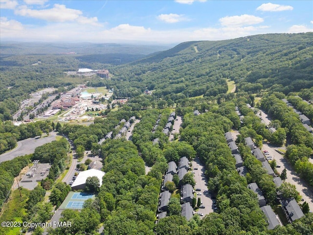 birds eye view of property featuring a view of trees