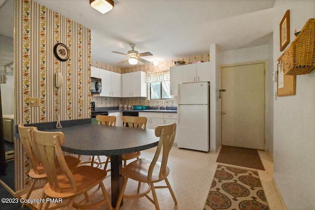 dining room with wallpapered walls and ceiling fan