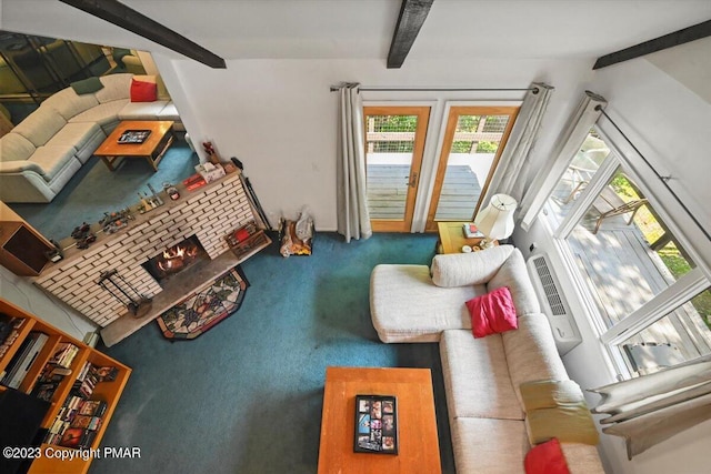 carpeted living room with lofted ceiling with beams and a brick fireplace